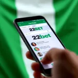 Mobile device displaying the 22bet app interface with Nigerian flag background